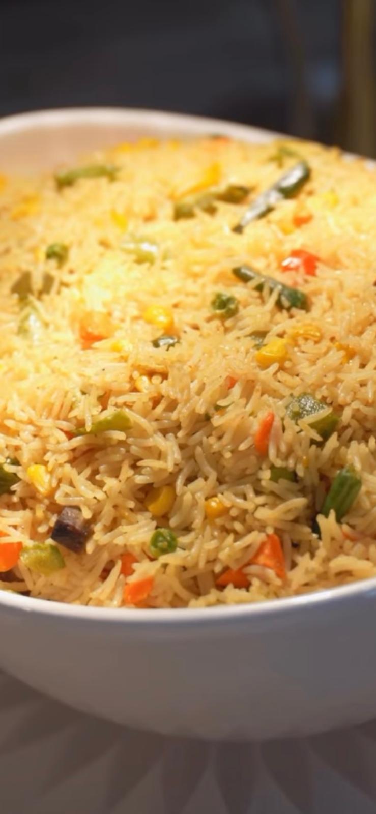 Fragrant seasoned rice cooked with fresh vegetables, corn, and African spices